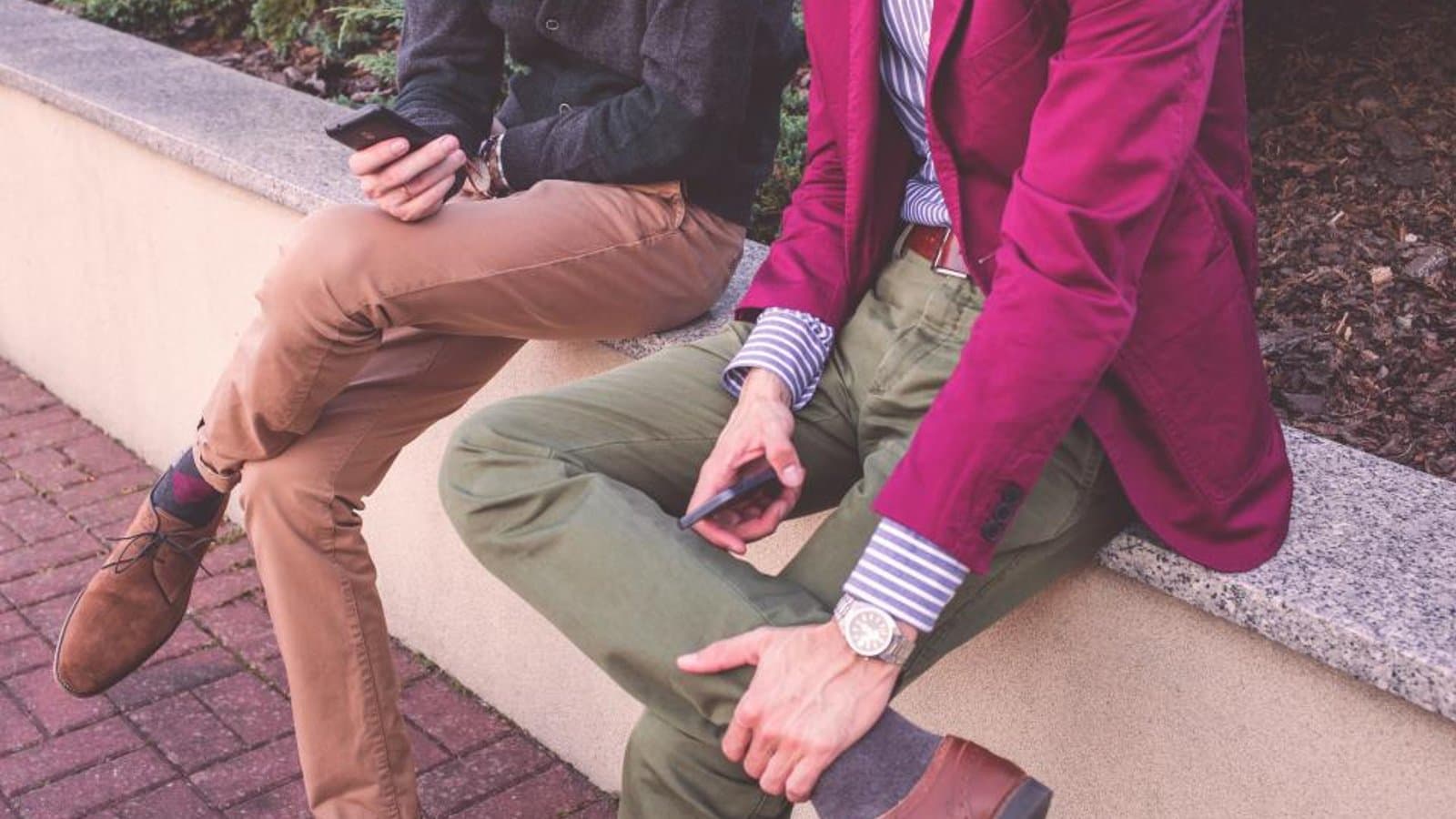 Two people sharing something on their phones